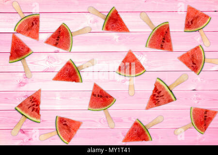 Many fresh watermelon popsicles on pink wooden planks, summer background concept Stock Photo