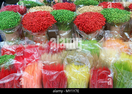 Multicolored paited  branches and ears are sold on the street during the spring traditional fair. CLoudy day outdoor shot Stock Photo