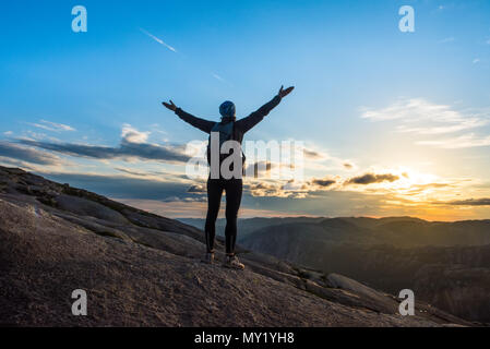 Woman successful hiking silhouette in mountains, motivation and inspiration in sunset Stock Photo