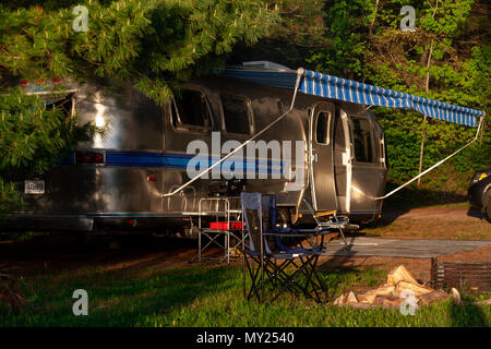 The iconic American made Airstream travel trailer sits in at a campsite at Driftwood Provincial Park in Ontario Canada. Airstream was founded in the l Stock Photo