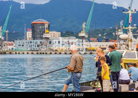 Batumi, Georgia - August 25, 2017: People fishing from the pier on the center of Batumi. Stock Photo