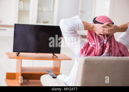 Arab businessman watching tv at home Stock Photo