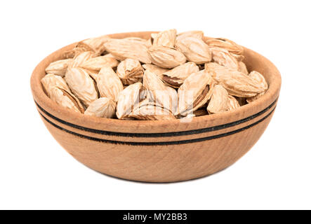 Wooden bowl with uzbek almonds on white background Stock Photo