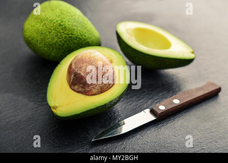 Fresh avocado  over black slate background Stock Photo