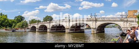 Panoramic view of Kingston Bridge over the River Thames, Kingston upon Thames, Greater London, UK on a sunny day with blue sky and fluffy white clouds Stock Photo