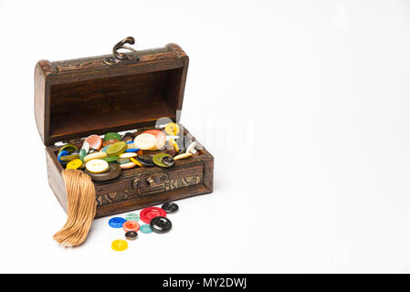 Small wooden box with buttons and threads on a white background Stock Photo