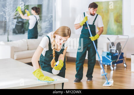 Cleaning service employees with professional equipment cleaning a private home after renovation Stock Photo