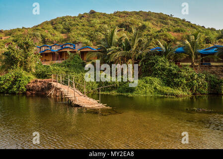 Ruined wooden bridge on the Sweet Lake on Arambol beach in Goa, India Stock Photo