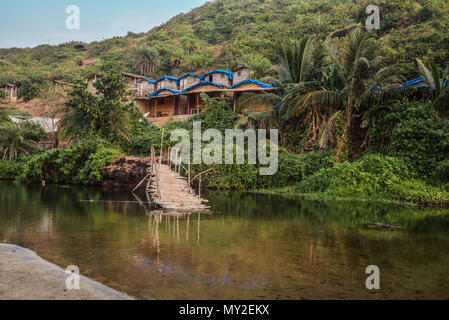 Ruined wooden bridge on the Sweet Lake on Arambol beach in Goa, India Stock Photo