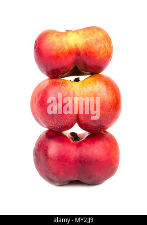 Three flat peaches piled together on a white background Stock Photo