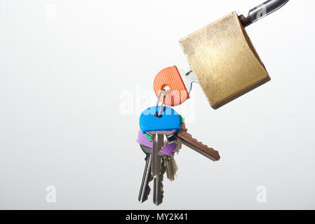 Ring with colorful keys inserted to lock close up view Stock Photo