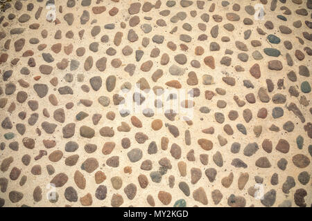 Сobblestone as paving stone, Conglomerate of assorted irregular pebbles in cement Stock Photo