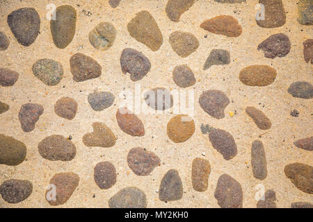 Сobblestone as paving stone, Conglomerate of assorted irregular pebbles in cement Stock Photo