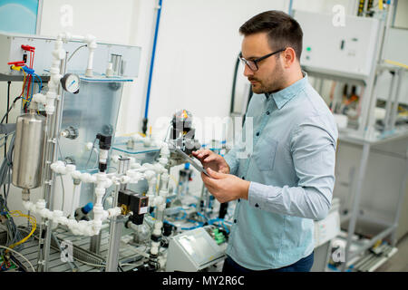 Handsome young man in the electronic workshop Stock Photo