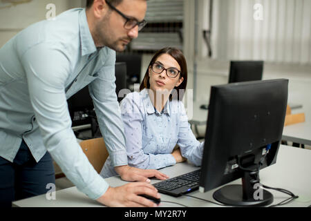 Young students presenting e-learning service in classroom Stock Photo