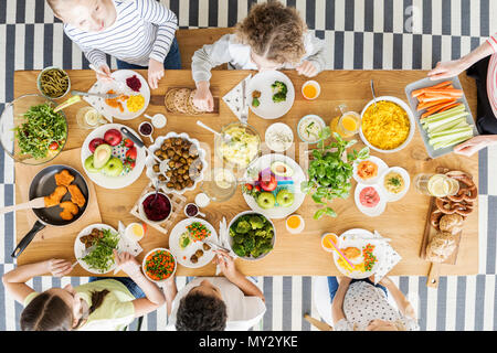 Top view on children eating healthy food during friend's birthday party Stock Photo