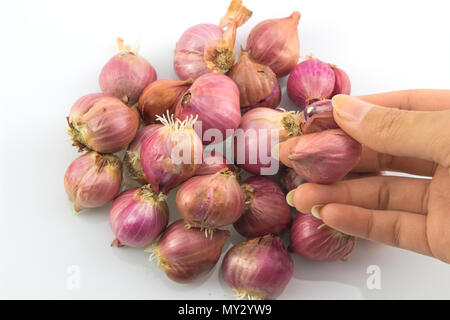 Pile of red onions with root on white background, Thai onions. Stock Photo