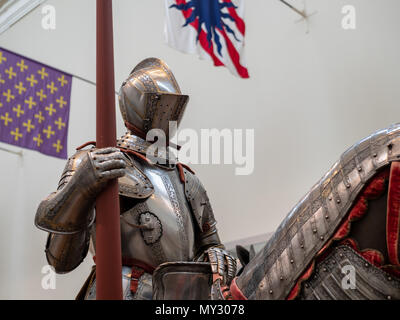 An exhibition of 15th century German plate armor around the time of Renaissance. The knight holds a land in his right arm while mounted. Stock Photo