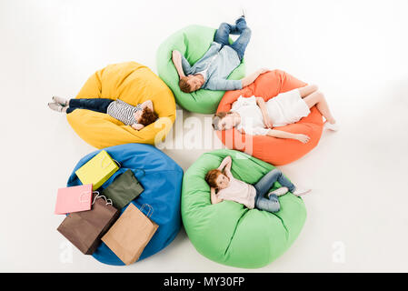 high angle view of family with two children resting on bean bag chairs after shopping Stock Photo