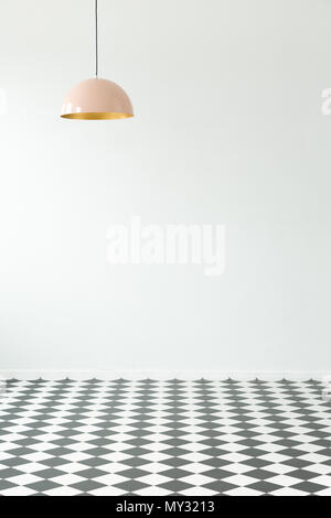 Empty room interior with checkered floor and pastel lamp. Place for your poster or furniture Stock Photo