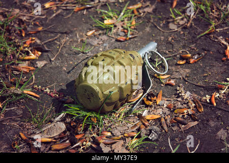 hand grenade grenade lying on the ground. Stock Photo