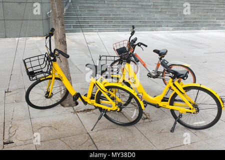 Station-free bike sharing yellow ofo bikes on the pavement in Singapore Stock Photo