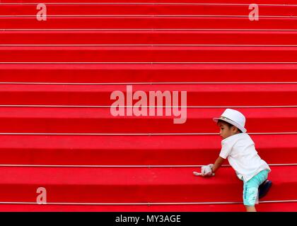 A child acends the famous red carpet steps leading to Palais des Festivals et des Congrès. Stock Photo