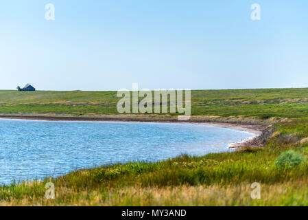 Summer landscape with field, lake and house Stock Photo