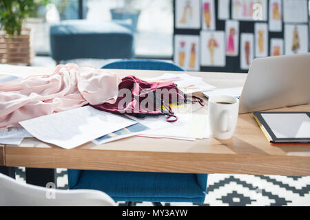 messy fashion designer workplace at modern office Stock Photo