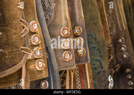 Traditional austrian and bavarian lederhosen (leather pants). Various lederhosen hanging in a row. Closeup of buttons. Stock Photo
