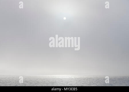 Lake Superior landscape with the sun and a fog rolling in at the Apostle Islands National Lakeshore, Bayfield, Wisconsin, USA Stock Photo