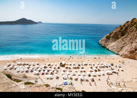 Tourists sunbathing and swimming on the Kaputas Beach, Kas, Antalya Turkey Stock Photo