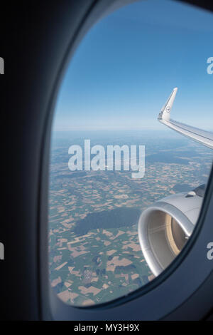 View from the window passenger seat at the engine of a Lufthansa A320-200 flying over central Europe. Stock Photo