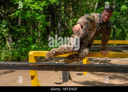 1st LT, May 24, 2018. Ryan Rodgers, 3rd Brigade Combat Team, 101st Airborne Division (Air Assault) navigates the six vaults obstacle during the Best Air Assault Competition at The Sabalauski Air Assault School May 24 at Fort Campbell. Air Assault qualified Soldiers of the 101st competed in several events such as a 12 mile road march, a written exam, a buddy run, rappelling, a medical evacuation and trauma lane, obstacle course and sling load inspection. () Stock Photo