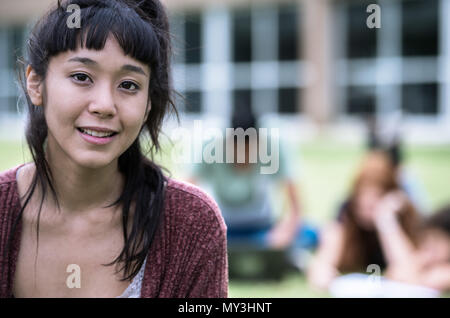 Young woman smiling outdoors, portrait Stock Photo
