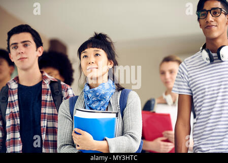 College students walking in corridor Stock Photo