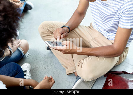 Students hanging out using smart phone Stock Photo