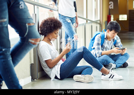 Students killing time in corridor between classes Stock Photo