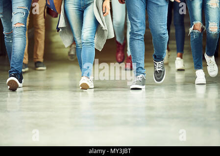 High school students walking in corridor, low section Stock Photo