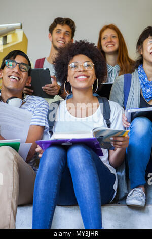 Group of college students studying on stairs, portrait Stock Photo