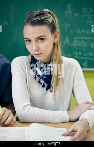 Young woman sitting in math class, portrait Stock Photo