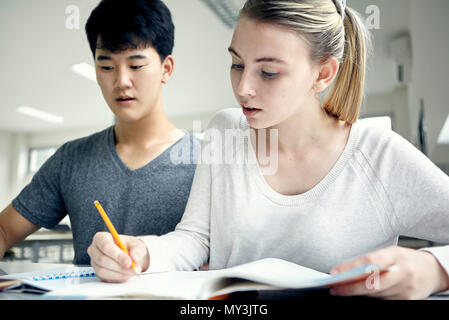 Students working on assignment at school Stock Photo