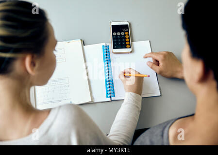Students working together on mathematics assignment Stock Photo