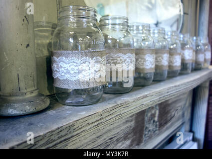 Row of Decorated Mason Jars on Fireplace Mantle Stock Photo