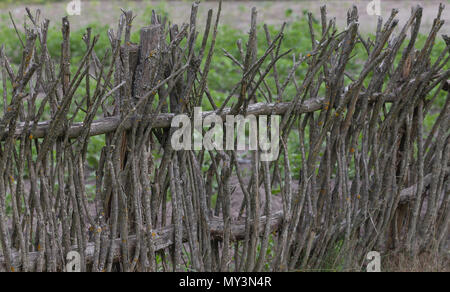 Old Rustic wattled fence with traditional style. Background. Stock Photo