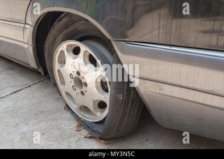 View of flat tires of car was abandoned. Stock Photo
