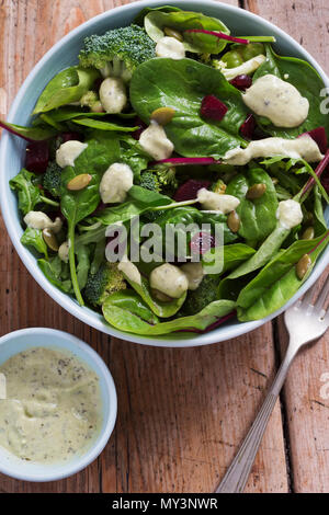 Superfood salad bowl. Mixed leaf salad with beetroot & pumpkin with creamy avocado dressing. Stock Photo