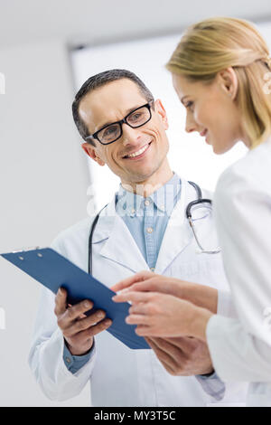 two doctors discussing diagnosis in hospital Stock Photo