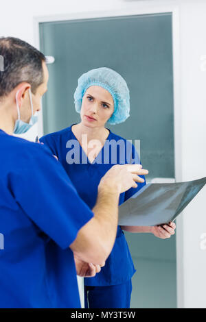 two surgeons discussing x-ray in hospital Stock Photo