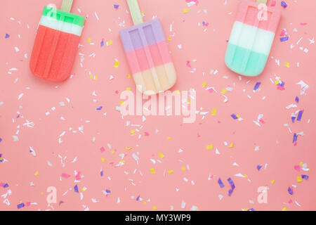 Table top view aerial image of food for summer holiday background concept.Flat lay arrangement variety ice cream pop stick on modern rustic pink paper Stock Photo